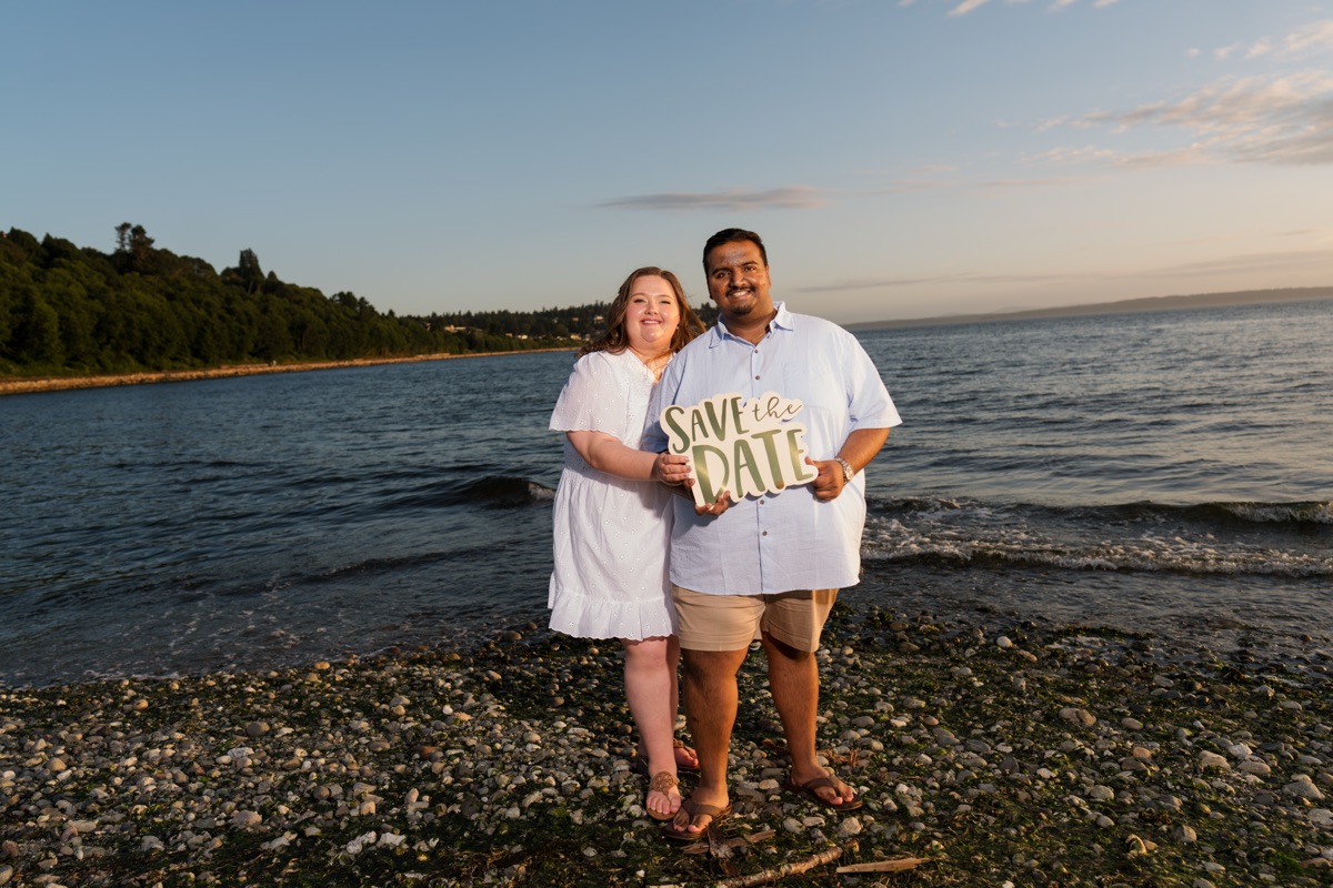 Adrian and Victoria with their Save the Date sign