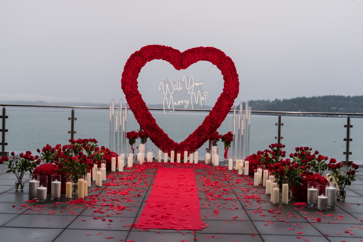The proposal setup — a rose heart arch over Lake Washington